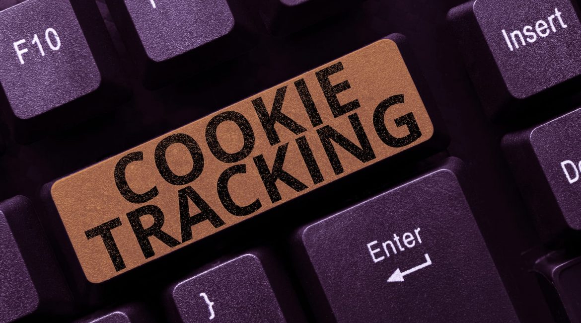 A close-up of a computer keyboard where a key has been replaced with a bronze-colored one that says 'COOKIE TRACKING', symbolizing the role of cookies in online privacy.