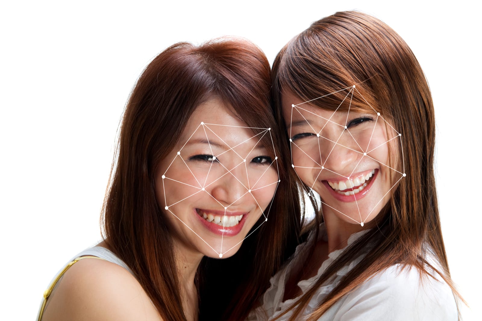 Two smiling East Asian women have their faces scanned by a digital facial recognition overlay, representing the use of biometric identification technology.